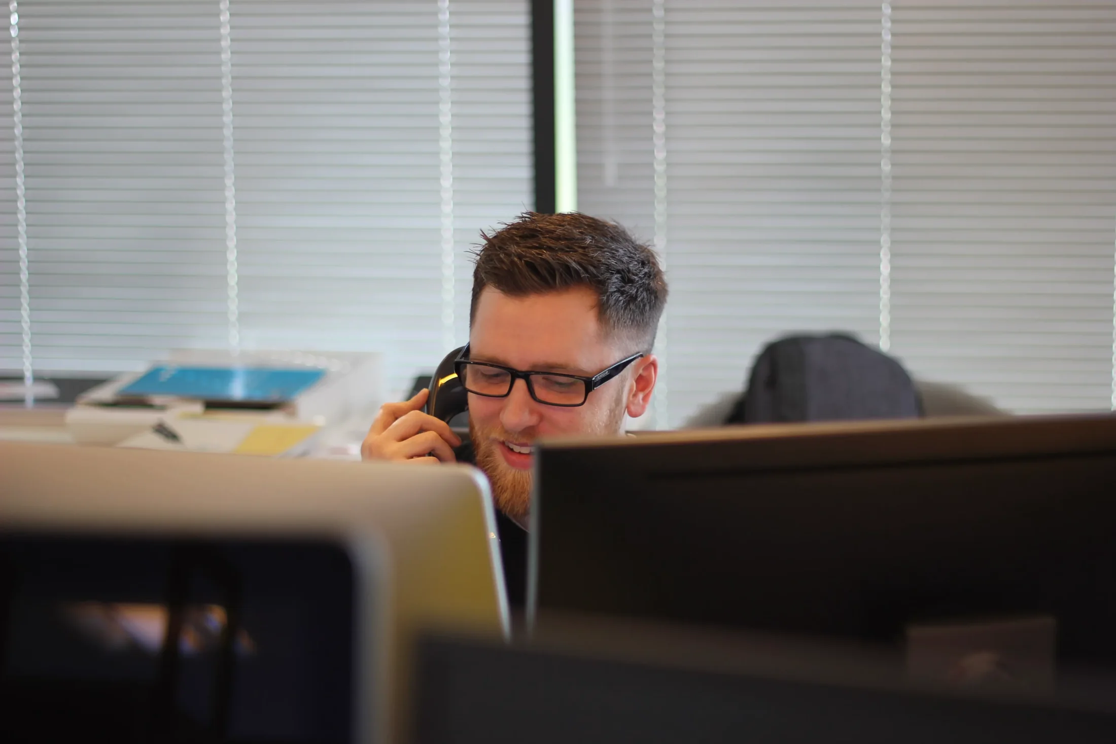 Contact center specialist handling a business call at a workstation